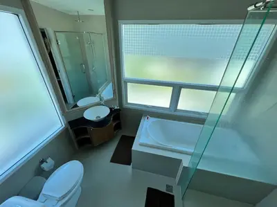a bathroom with a toilet and a sink and a mirror at Stunning 4-BR House with Inviting Swimming Pool in Kamala Beach