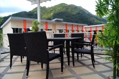 a black table and chairs on a balcony at Stunning 4-BR House with Inviting Swimming Pool in Kamala Beach
