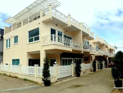 a large building with a balcony on top of it at Stunning 4-BR House with Inviting Swimming Pool in Kamala Beach