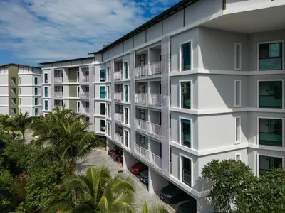 an aerial view of a white building with palm trees at The Title V Rawai by Beringela in Phuket Town