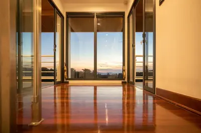 an empty hallway with glass doors and a view at Phuket Superior Sunrise Sea View Private Pool Villa in Kata Beach