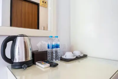 a kitchen counter with bottles of water and a kettle at Patong Central Residence & Apartment in Patong Beach
