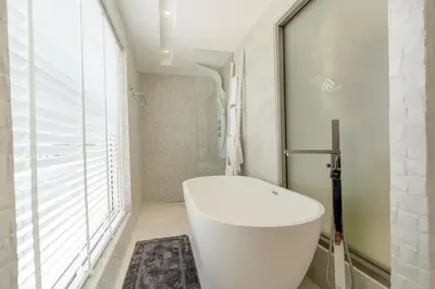 a bathroom with a white toilet and a window at Exquisite Pool Residence A19: Aesthetics and Luxury Combined in Bang Tao Beach