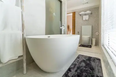 a large white bath tub in a bathroom at Exquisite Pool Residence A19: Aesthetics and Luxury Combined in Bang Tao Beach