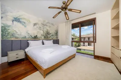 a bedroom with a bed and a ceiling fan at 4BR Penthouse Royal Marina 6B Private Rooftop Pool with 360 View in Phuket Town