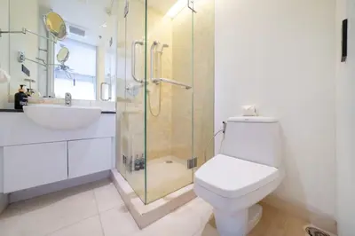 a bathroom with a toilet and a shower and a sink at 4BR Penthouse Royal Marina 6B Private Rooftop Pool with 360 View in Phuket Town