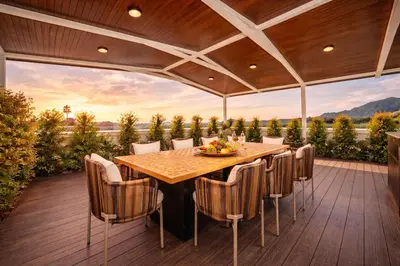 a patio with a table and chairs on a deck at 4BR Penthouse Royal Marina 6B Private Rooftop Pool with 360 View in Phuket Town