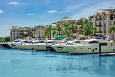a row of boats docked in the water at a resort at 4BR Penthouse Royal Marina 6B Private Rooftop Pool with 360 View in Phuket Town
