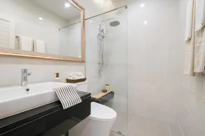 a bathroom with a sink and a toilet and a shower at Chao Wilai Residence I Naiyang Beach I HKT Airport in Nai Yang Beach
