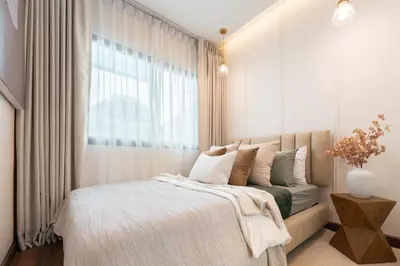 a bedroom with a bed and a window at Chao Wilai Residence I Naiyang Beach I HKT Airport in Nai Yang Beach
