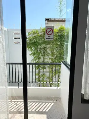 a window with a no smoking sign on a balcony at The Elements Boutique House in Phuket Town