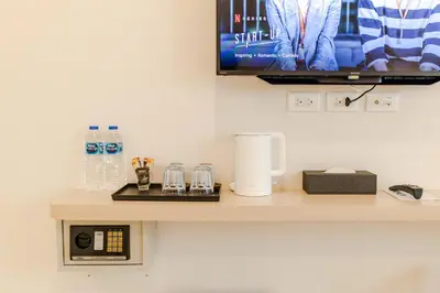 a counter with a tv on a wall at The Elements Boutique House in Phuket Town