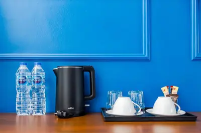 a coffee maker sitting on a table with water bottles at The Elements Boutique House in Phuket Town