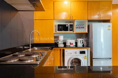 a kitchen with a stove and a washer and dryer at The Unity and The Bliss Patong Residence in Patong Beach
