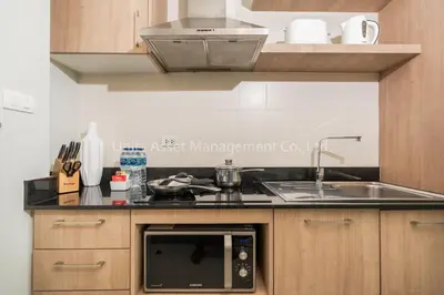 a kitchen with a sink and a microwave at The Unity and The Bliss Patong Residence in Patong Beach