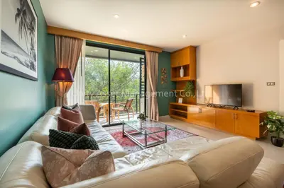 a living room with a couch and a television at The Unity and The Bliss Patong Residence in Patong Beach