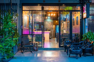 an entrance to a store with benches in front of it at Black Panther Hostel in Phuket Town