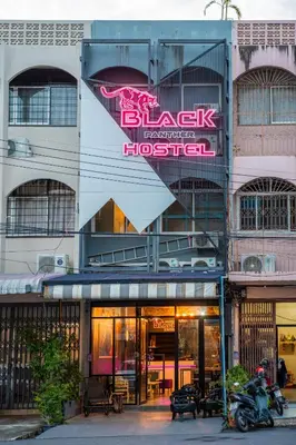 a building with a sign on the side of it at Black Panther Hostel in Phuket Town