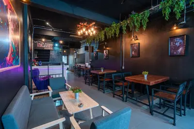 a restaurant with tables and chairs in a room at Black Panther Hostel in Phuket Town