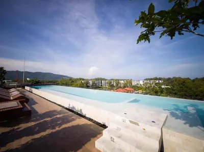 a large swimming pool with a view of a city at Skypark Laguna Rooftop Pool Apartment near Bang Tao Beach in Bang Tao Beach