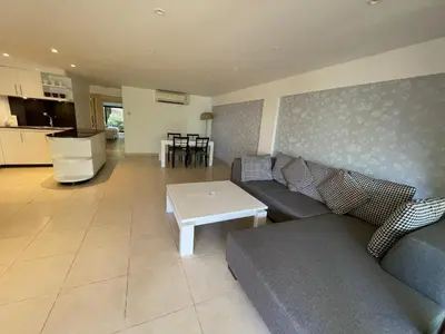 a living room with a couch and a table at Peaceful retreat at Kalim Bay - pool bar garden in Patong Beach