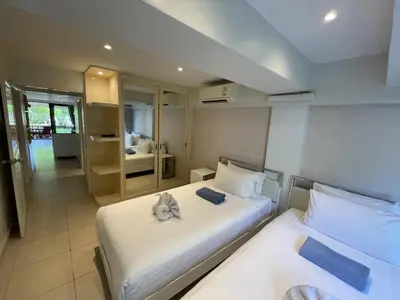 a hotel room with two beds and a bathroom at Peaceful retreat at Kalim Bay - pool bar garden in Patong Beach