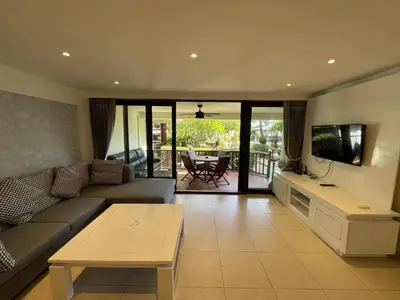a living room with a couch and a tv and a table at Peaceful retreat at Kalim Bay - pool bar garden in Patong Beach