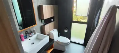 a bathroom with a white toilet and a sink at Relife SPB in Phuket Town