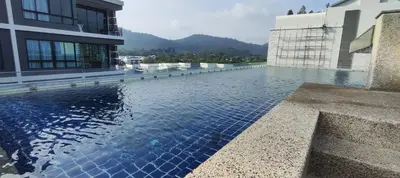 a swimming pool on the side of a building at Relife SPB in Phuket Town
