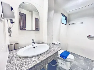 a bathroom with a sink and a toilet and a mirror at 88 House Patong in Patong Beach