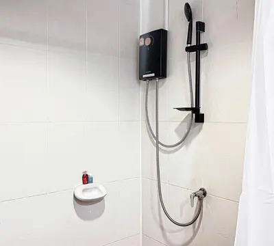 a shower in a bathroom with a phone on the wall at 88 House Patong in Patong Beach