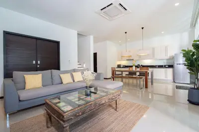 a living room with a couch and a table at Tropical Garden Villa - Oxygen Bangtao Beach in Bang Tao Beach