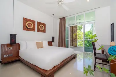 a bedroom with a white bed and a window at Tropical Garden Villa - Oxygen Bangtao Beach in Bang Tao Beach