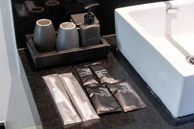 a black counter with a drawer with two cups and packets at Tropical Garden Villa - Oxygen Bangtao Beach in Bang Tao Beach