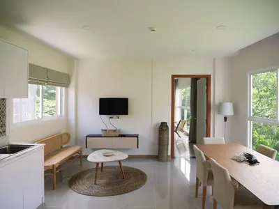 a kitchen and living room with a table and a dining room at Karon beach apartment & sea view pool in Karon Beach