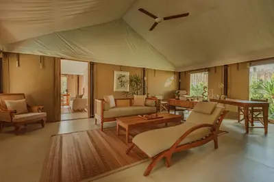 a living room with furniture and a ceiling fan at Twinpalms Tented Camp Phuket in Bang Tao Beach