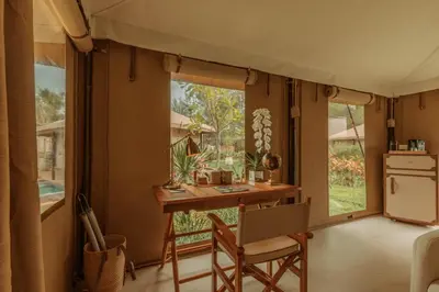 a kitchen with a table and a desk in a tent at Twinpalms Tented Camp Phuket in Bang Tao Beach