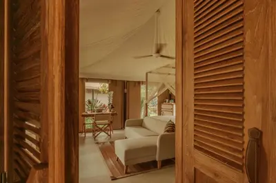 a living room with a couch and a table at Twinpalms Tented Camp Phuket in Bang Tao Beach
