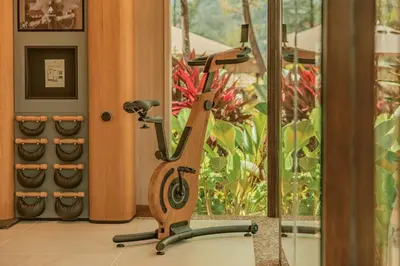 an exercise bike in a room with a window at Twinpalms Tented Camp Phuket in Bang Tao Beach