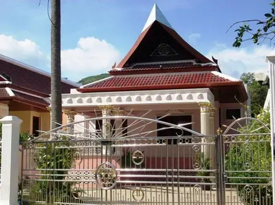 a small house with a gate in front of it at Majestic Villas Phuket in Rawai Beach