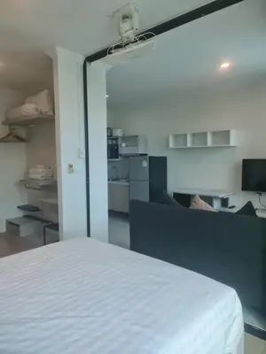 a bedroom with a white bed and a couch at At Laguna at Zcape Condo in Bang Tao Beach
