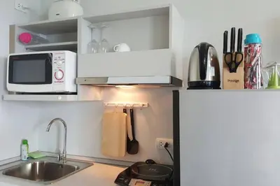 a kitchen with a sink and a microwave at At Laguna at Zcape Condo in Bang Tao Beach