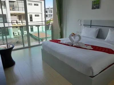 a bedroom with a bed with two swans on it at Toto Residence in Ao Nang Beach