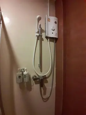 a shower in a bathroom with a hair dryer at Toto Residence in Ao Nang Beach