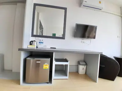 a desk with a sink and a mirror on a wall at Toto Residence in Ao Nang Beach