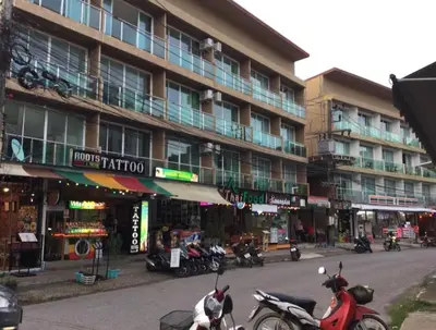 two motorcycles parked in front of a building at Toto Residence in Ao Nang Beach