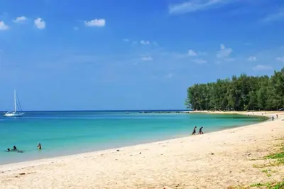 a group of people swimming in the water on a beach at 2 Bedroom Apartment in Naiyang - The Title Residences, Naiyang in Nai Yang Beach