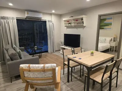 a living room with a table and a couch at 2 Bedroom Apartment in Naiyang - The Title Residences, Naiyang in Nai Yang Beach