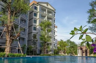 an exterior view of a building with a swimming pool at 2 Bedroom Apartment in Naiyang - The Title Residences, Naiyang in Nai Yang Beach