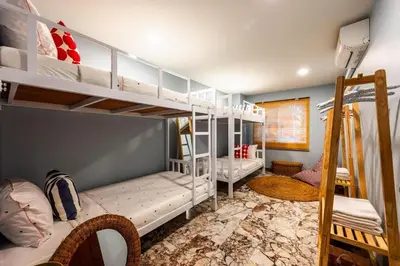 a room with two bunk beds and a bed at Kinnaree Grand Villa - pool, panoramic views, maid in Kamala Beach